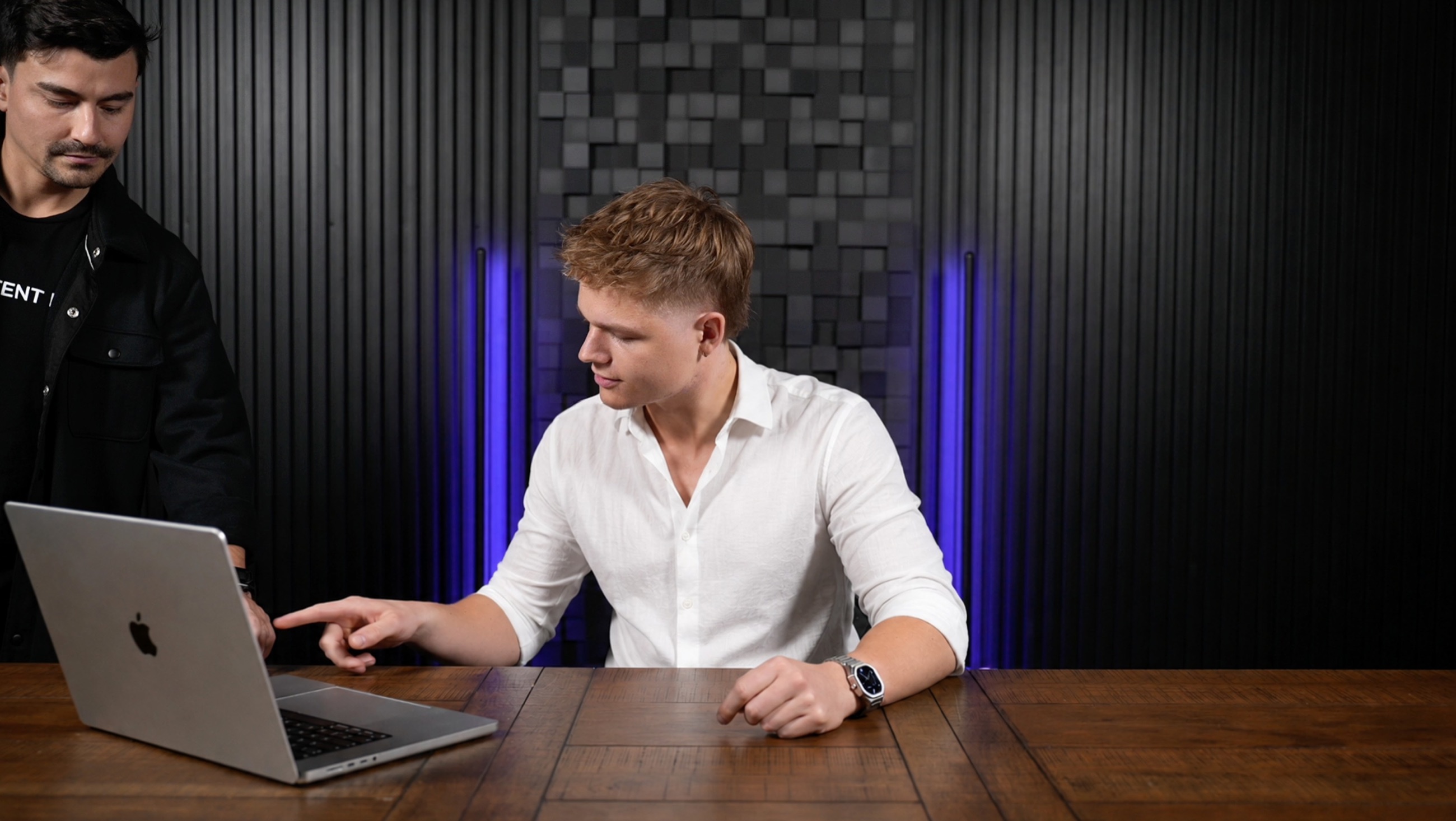 Thor Bunde reviewing work on a laptop with a DenWay team member